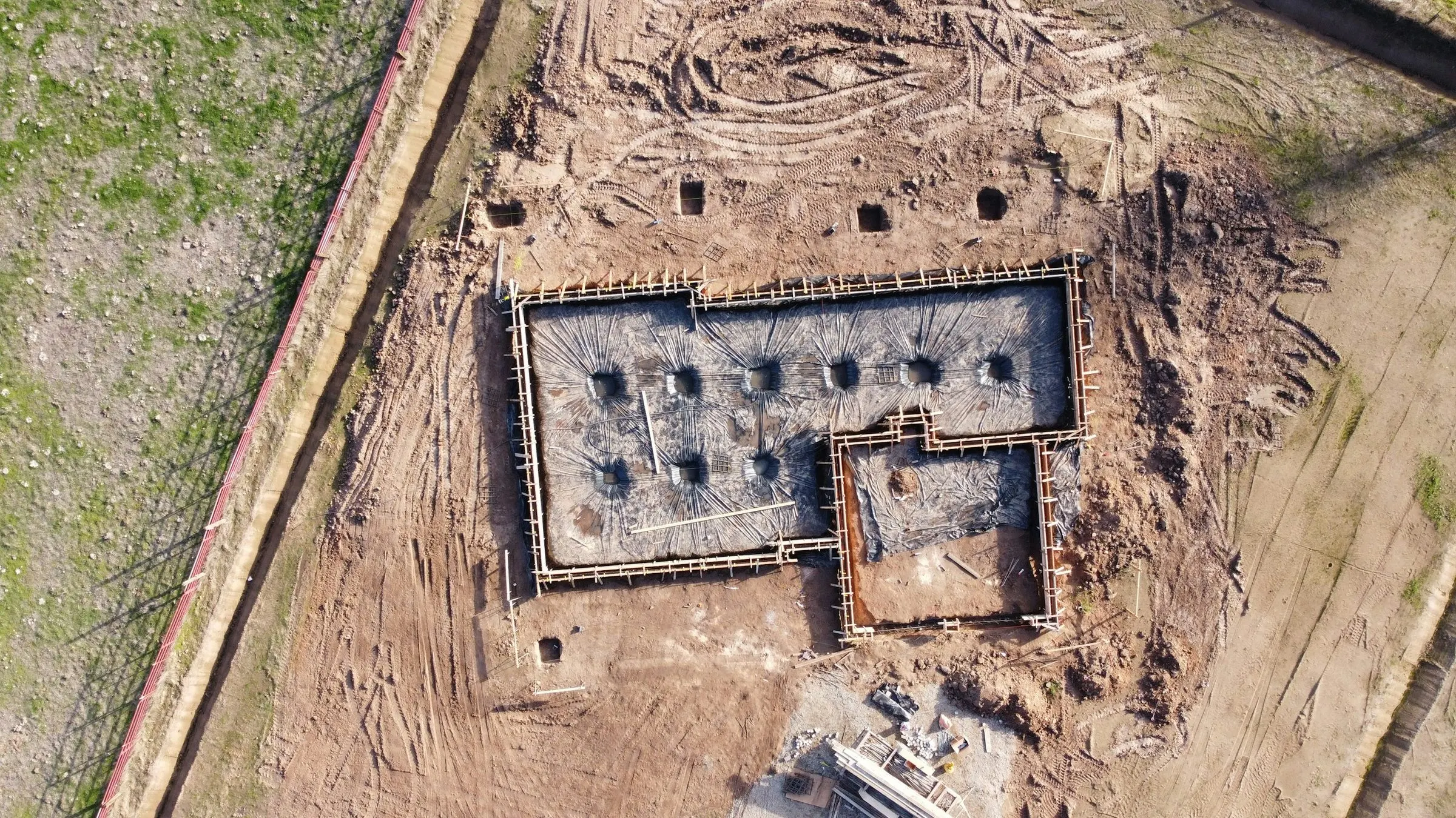 Aerial view of a new building’s foundations set out on a cleared site